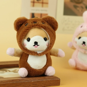 Close-up of cute Shiba Inu plush keychain wearing a brown bear hood with pink blush detail