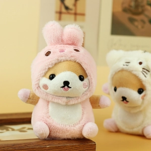 Close-up of plush shiba inu charm wearing a pink rabbit hoodie with detailed embroidery