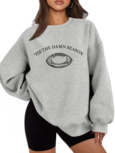 Detail of grey oversized sweatshirt showing 'TIS THE DAMN SEASON rugby graphic print