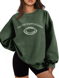 Detail of white football graphic and 'Tis the Damn Season' text on green sweatshirt