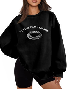 Detail of white football graphic and 'Tis The Damn Season text on black fleece sweatshirt