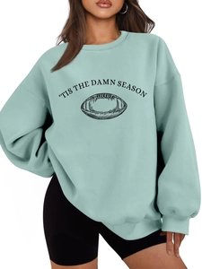 Detail of mint green sweatshirt featuring tis the damn season and rugby graphic print