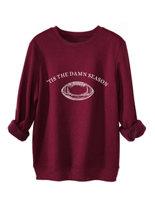Detail view of wine red crewneck sweatshirt with 'Tis the Damn Season' print and ribbed cuffs