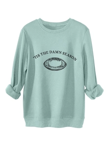 Detail of mint green sweatshirt with 'tis the damn season text and football graphic