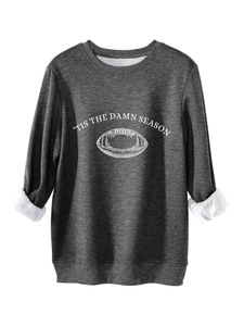 Detail of dark grey crewneck sweatshirt with 'Tis the Damn Season' print and football motif