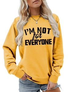 Close-up of ginger yellow sweatshirt featuring I'M NOT FOR EVERYONE slogan and ribbed cuffs