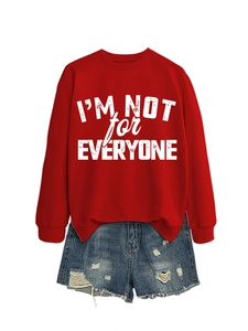 Detail of red sweatshirt with I'M NOT FOR EVERYONE text and ripped denim shorts