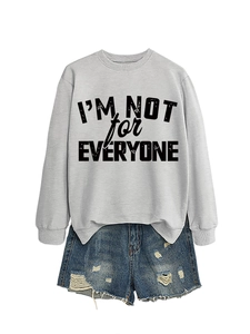 Detail of grey sweatshirt with 'I'M NOT FOR EVERYONE' print and distressed denim shorts