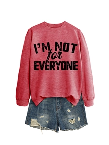 Detail of red crewneck sweatshirt with black I'M NOT FOR EVERYONE text and distressed denim