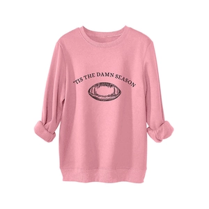 Pink crewneck sweatshirt with 'Tis The Damn Season slogan and football graphic print