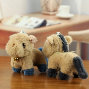 Close-up of cute plush pony keychain with soft fur, golden bell and silver bead chain
