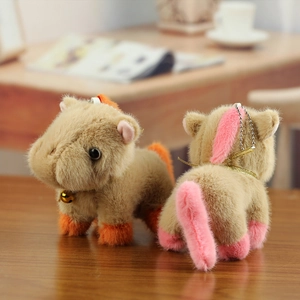 Detailed view of plush pony charms with soft faux fur, gold bells and metal ball chains