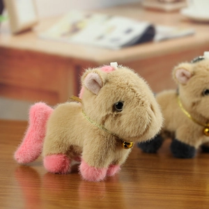 Close-up of cute capybara plush keychain with pink mane and small golden bell charm