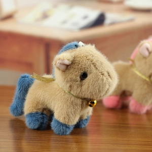 Close-up of plush pony toy with light brown fur, blue mane and a golden bell accessory