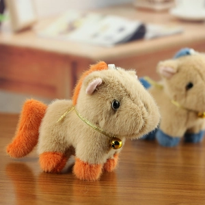 Close-up of khaki plush horse pendant with orange mane and a small golden bell