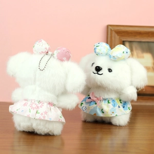 Detailed front and back views of plush puppy keychains in pink and blue floral dresses