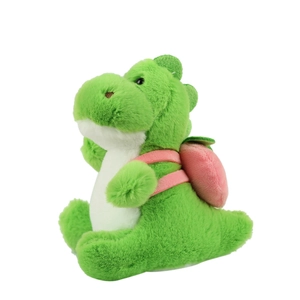 Cute green plush dinosaur toy with pink strawberry backpack on a white background