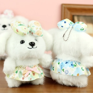 Front and back detail of plush puppy charms with floral dresses and chain hooks