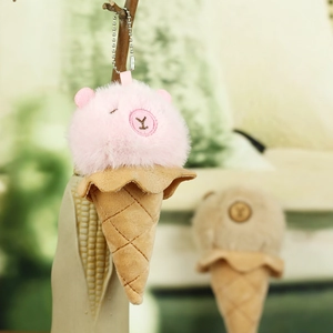 Macro shot of plush capybara ice cream keychain with pink fur and a brown fabric cone