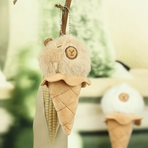 Close-up of plush ice cream capybara keychain with embroidery and silver chain