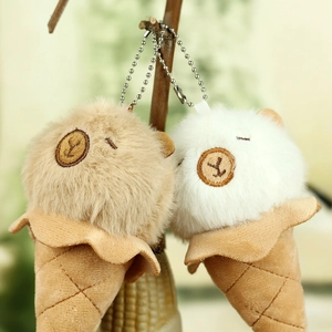 Detail of plush ice cream capybara keychains with waffle cone texture on tree branch