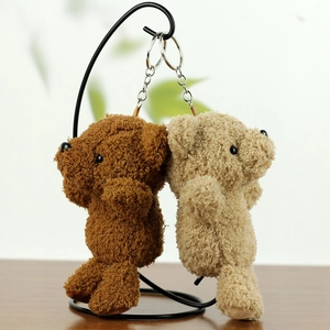Detailed close-up of brown and beige plush teddy bear charms with silver keychains