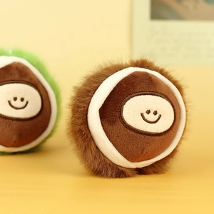 Close-up of cute chestnut plush pendant with soft long-hair fur and embroidered smile