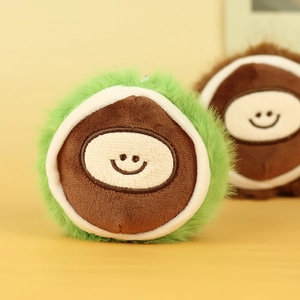 Close-up of cute plush chestnut keychain with embroidery face and soft texture details