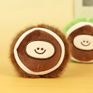Close-up of cute plush chestnut keychain with a smiling face and soft brown faux fur