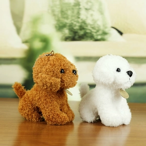 Close-up of plush teddy and bichon dog charms with soft curly fur and metal chains