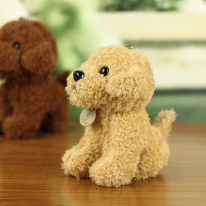 Close-up of cute curly plush teddy dog keychain with a wooden tag and metal chain