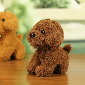 Close-up of brown teddy dog plush keychain with curly fur and metal clasp