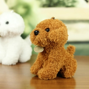 Close-up of brown teddy dog plush toy with soft curly fur and LOVE branded round tag