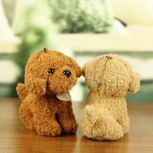Detail of cute teddy dog plush keychains with metal chains and engraved love pendants