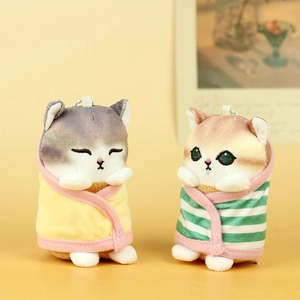 Detail of plush cat keychains wrapped in towels with delicate facial embroidery