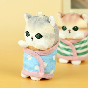 Close-up of cute plush cat keychain with embroidered eyes and polka dot towel wrap