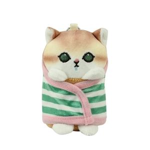 Cute plush cat keychain wearing green striped shark robe on a white background