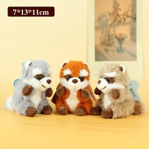 Three cute raccoon plush keychain dolls in grey, orange, and brown with soft long fur