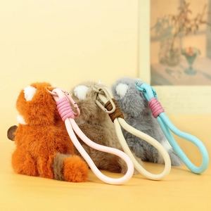Detailed plush animal charms in orange brown and gray with woven ropes and metal clips