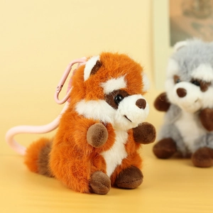 Plush raccoon keychain accessory with fluffy orange and brown fur and pink clip