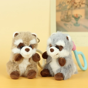 Detail view of brown and gray fluffy plush raccoon charms with colorful plastic hooks