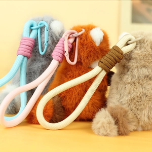 Three plush raccoon pendants with colorful woven lanyards and matching carabiner clips