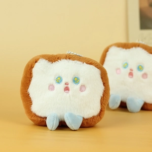 Close-up of cute toast plush keychain with embroidered stars eyes and soft blue feet
