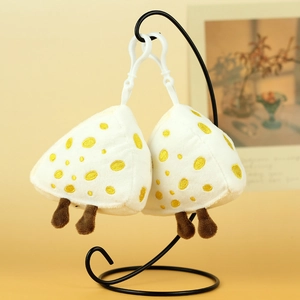 Detail of plush toast keychains with white hooks hanging on a black metal stand