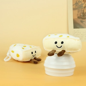 Detail of plush toast pendant with cute smiley face and soft 3D brown legs on yellow backdrop
