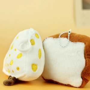 Close-up of cute plush bread toast and cheese pendants with soft texture and hooks