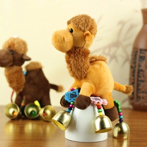 Detail of plush camel keychain with colorful wooden beads and golden bells