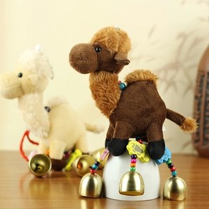 Detailed view of plush camel keychain with colorful beads, wood charms and gold bell