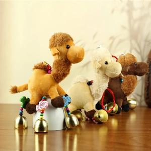 Detail of plush camel pendants in brown and white with ethnic style beads and bells