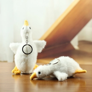 Cute white plush goose keychain set with soft fur and orange beak for bag decoration